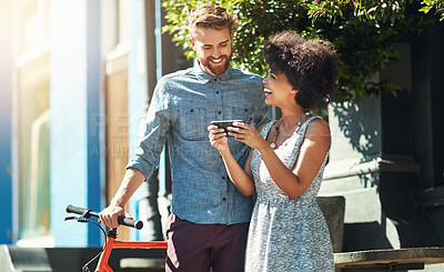 Buy stock photo Phone, bicycle and couple on street with smile, connection and networking on social media. Smartphone, happy man and woman in city with mobile app, bike or online communication for sustainable travel