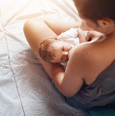 Buy stock photo Mom, boy baby and breastfeeding on bed for development growth, nutrition or digestive health in bedroom. Love, top view and woman with newborn child for natural milk, wellness or bonding in home