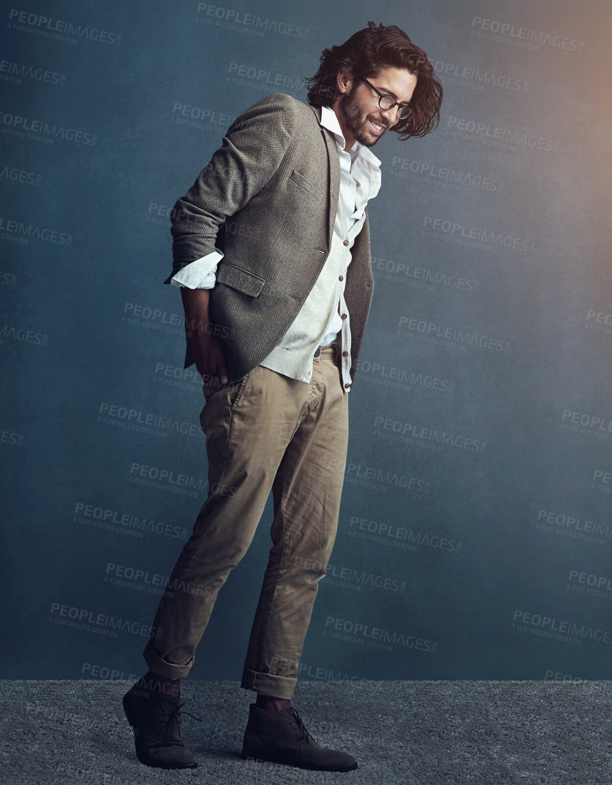 Buy stock photo Charming, businessman and hands in pocket with messy suit for fashion trend isolated in studio. Smile, male person and creative professional with pride and ambition in job with mockup and lens flare