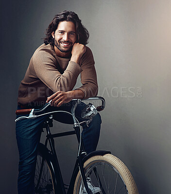 Buy stock photo Portrait, smile and man with bike, travel and wellness with sustainability on grey studio background. Person, model and guy with transport, eco friendly and cycling with fitness, carbon footprint