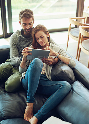 Buy stock photo Happy, couple and hug with tablet on sofa for streaming, movie selection or tv choice at home. Smile, man and woman with technology and love embrace on couch for bonding, care and entertainment