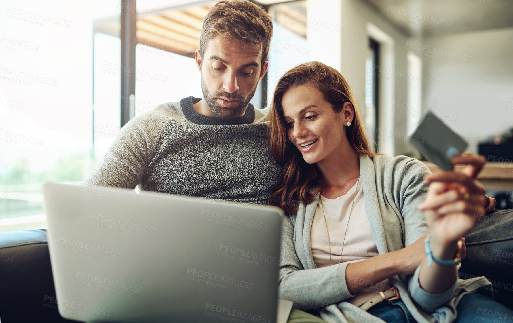 Buy stock photo Credit card, laptop and online shopping with couple on sofa in living room of home for payment or purchase. Computer, love or smile with happy man and woman in apartment together for ecommerce