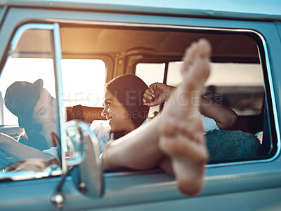 Buy stock photo Relax, happy and lesbian couple on road trip in van at sunset in countryside for holiday. Smile, love and queer women in vehicle for bonding, talking and traveling together on vacation with adventure