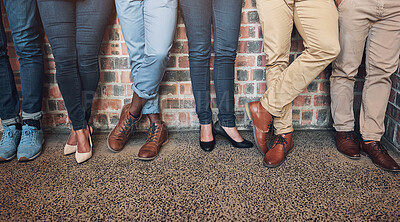 Buy stock photo Legs, group or business people in waiting room for recruitment, interview or hr opportunity. Shoes, candidates or row in work office at startup for hiring, human resources or job search on brick wall