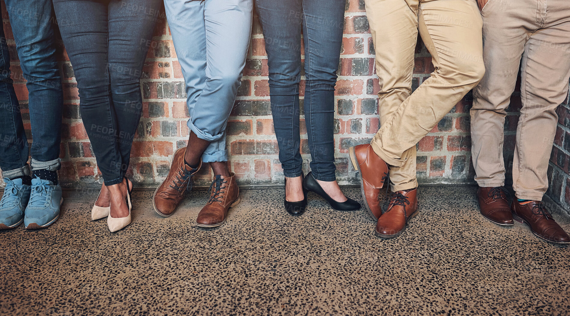 Buy stock photo Legs, group or business people in waiting room for recruitment, interview or hr opportunity. Shoes, candidates or row in work office at startup for hiring, human resources or job search on brick wall