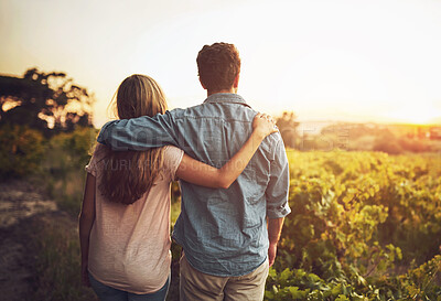 Buy stock photo Back, hug and couple in morning, love and together with care, field and date for anniversary in outdoor. Sunrise, partner and person with embrace, nature and peace in grass and relax in Texas in farm