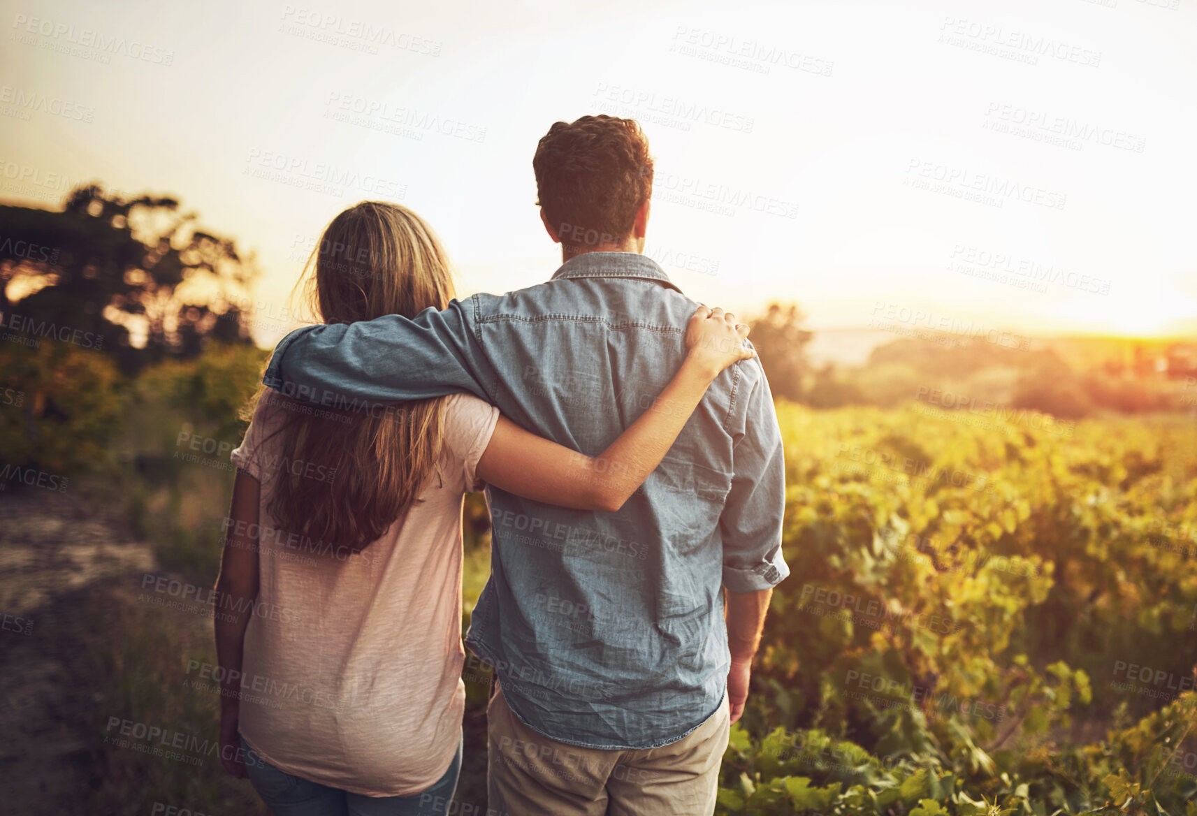 Buy stock photo Back, hug and couple in morning, love and together with care, field and date for anniversary in outdoor. Sunrise, partner and person with embrace, nature and peace in grass and relax in Texas in farm