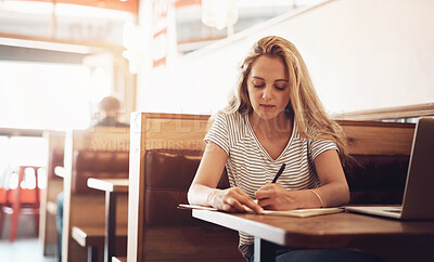 Buy stock photo Woman, laptop or writing on paper in cafe for idea, elearning and online research. Female person, documents and technology in restaurant for remote working, studying and planning or internet news