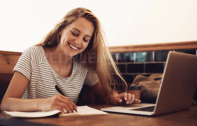 Buy stock photo Woman, smile and writing at cafe with laptop as university student for elearning or online education. Female learner, happy and satisfied with studying or revision and research for college exams