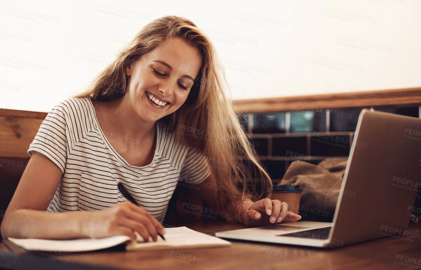 Buy stock photo Woman, smile and writing at cafe with laptop as university student for elearning or online education. Female learner, happy and satisfied with studying or revision and research for college exams