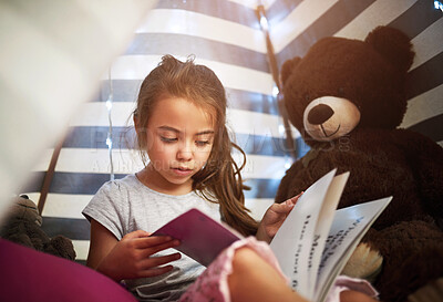 Buy stock photo Learning, kid and reading book in home tent for education, language development or knowledge in bedroom. Girl child, fairytale or studying fantasy story, information or hobby with teddy bear in house