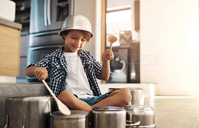 Buy stock photo Children, drums and pots with boy on floor of home kitchen, having fun making loud music sound. Fantasy, happy or smile and confident young kid playing cookware utensils in apartment for audio