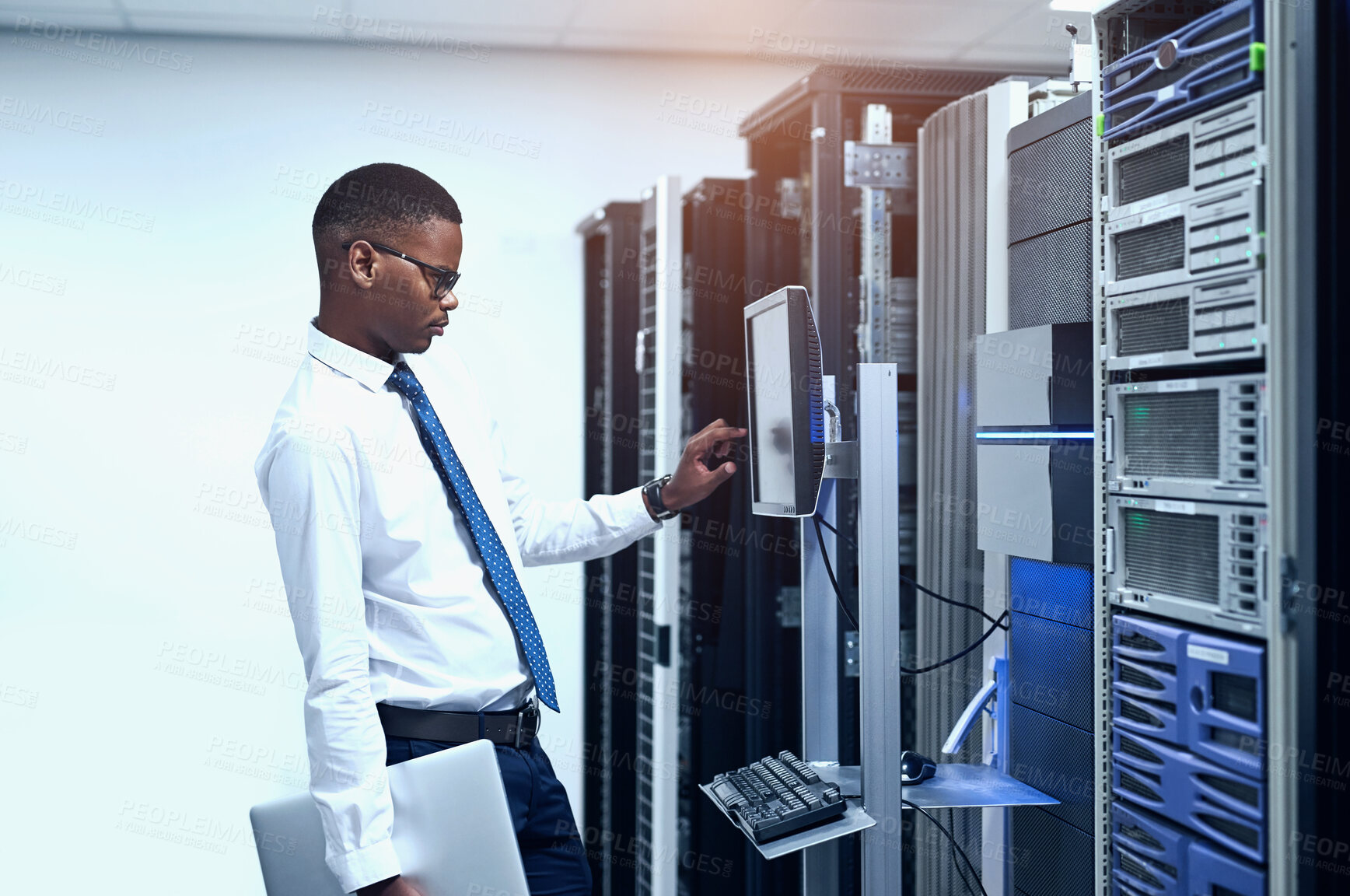 Buy stock photo Data center, engineer and black man with pc in server room for information technology, maintenance or software update. Cyber, code and technician for troubleshooting, configuration or system recovery