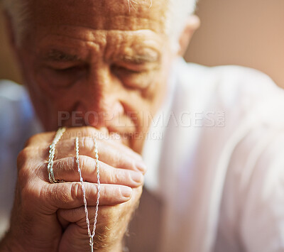 Buy stock photo Senior man, catholic and praying in home with rosary for hail mary, God and Jesus Christ or heaven. Elderly person, religion and worship for faith, forgiveness or Holy spirit as Christian saint