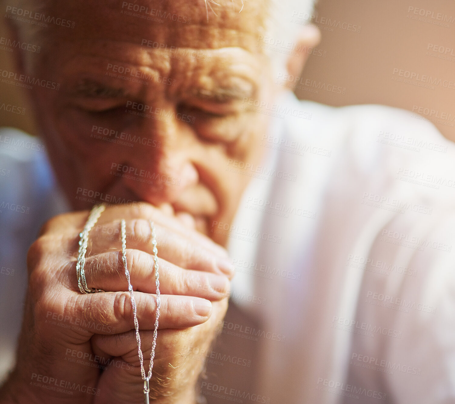 Buy stock photo Senior man, catholic and praying in home with rosary for hail mary, God and Jesus Christ or heaven. Elderly person, religion and worship for faith, forgiveness or Holy spirit as Christian saint