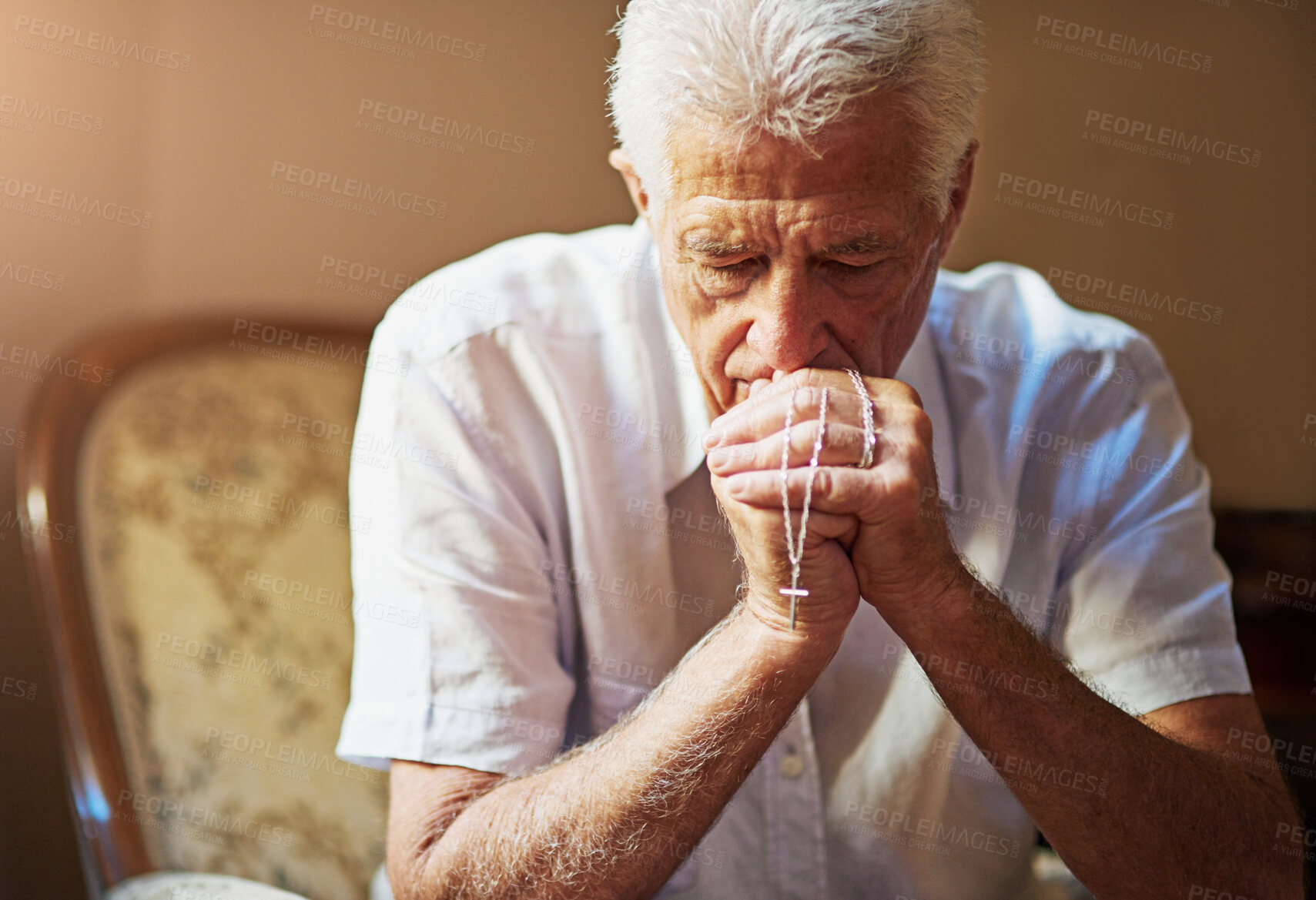 Buy stock photo Home, rosary and elderly man with praying on sofa for spiritual healing, faith or worship to God. Retirement, Christian and senior person with crucifix for prayer, religion or guidance in Holy Spirit