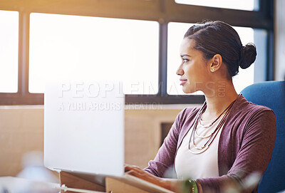 Buy stock photo Woman laptop and thinking at startup by window with smile for inspiration, idea or typing at media company. Person, writer and computer in modern office for choice, decision or job at creative agency