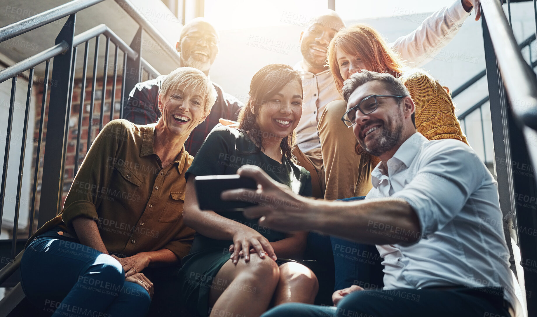 Buy stock photo Group, people and stairs with smile or phone, international in office with lens flare. Crowd, diversity or happiness with mobile technology for company profile picture, team building for employees