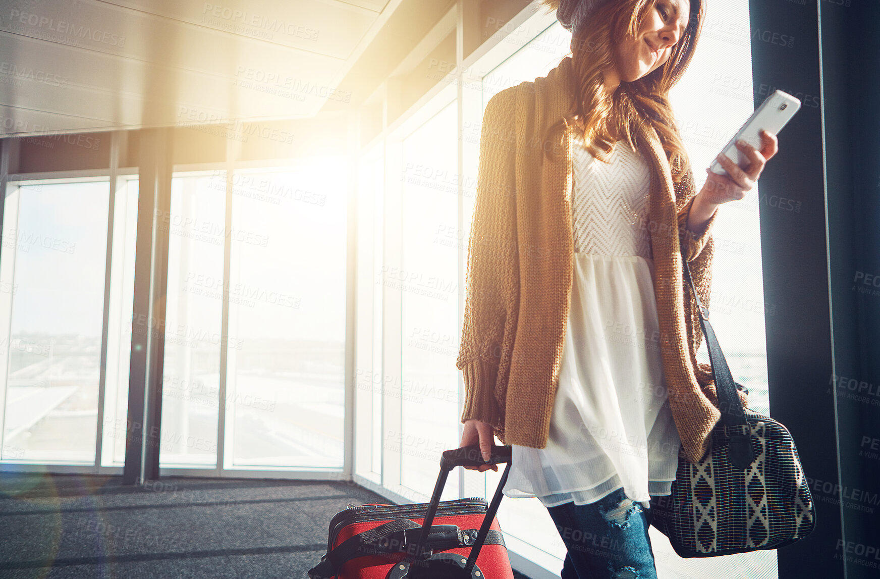 Buy stock photo Airport, luggage and woman with smartphone, typing and social media with getaway trip, vacation and sunshine. Person, human or girl with cellphone, lens flare and connection with holiday or departure