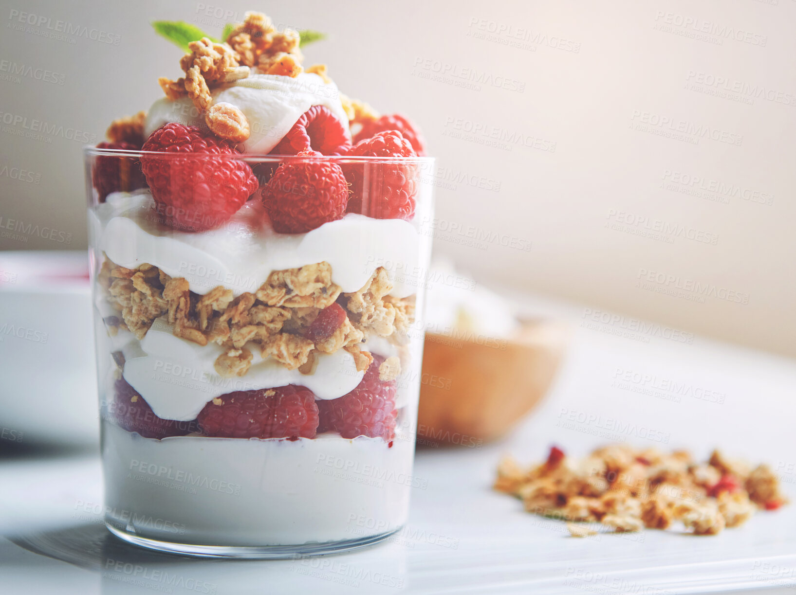 Buy stock photo Breakfast, jar and yogurt with raspberry on table for vegan food, health and cereal in morning. Fruit, vitamin and dairy in glass container with protein for weight loss, organic nutrition and diet