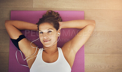 Buy stock photo Woman, relax and listening to music on yoga mat with portrait for health, wellness and exercise. Happy face of young person with audio streaming of workout podcast with break or rest on floor above