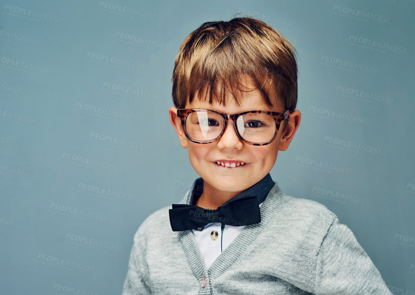 Buy stock photo Fashion, glasses and portrait of boy genius in studio isolated on blue background for intelligence. Bowtie, eyewear and style with face of geek or nerd kid in trendy outfit for child development