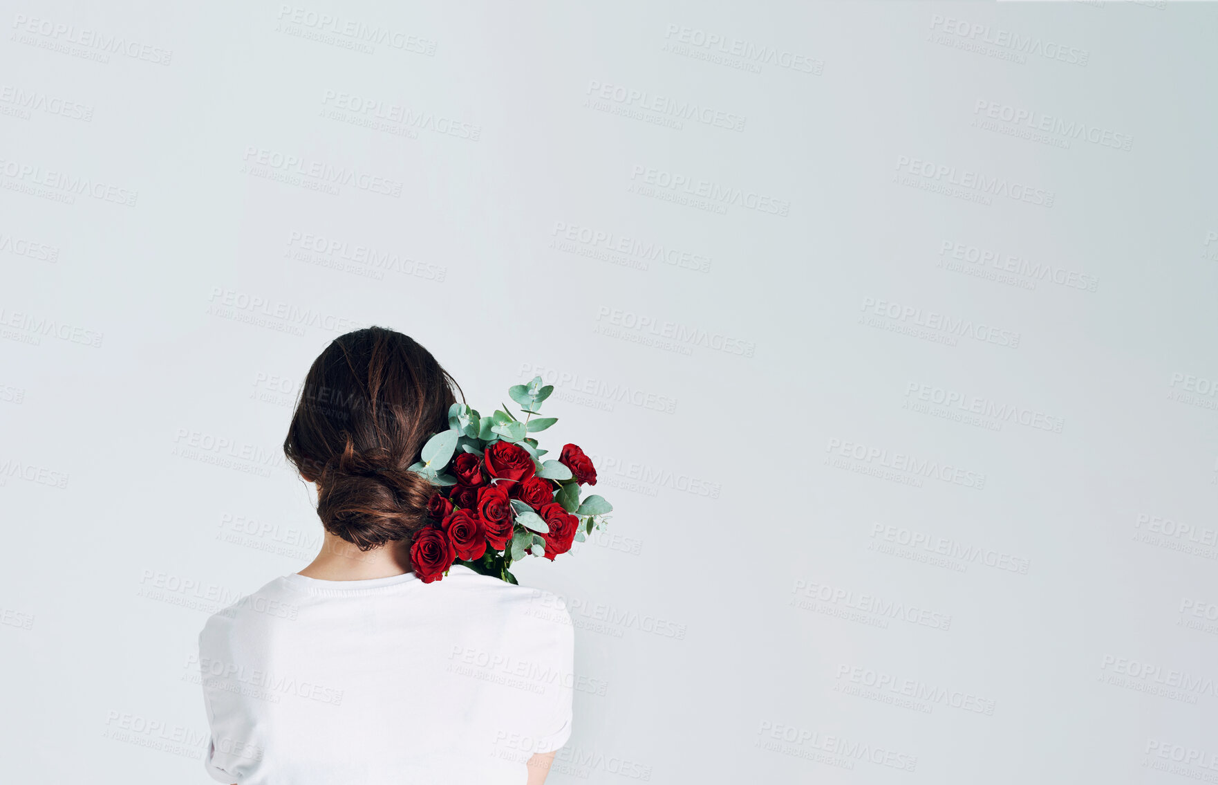 Buy stock photo Woman, back and rose flowers on shoulder for love with anniversary present, mockup space and natural product in studio. Female person, floral bouquet and leaves for romantic gift by white background