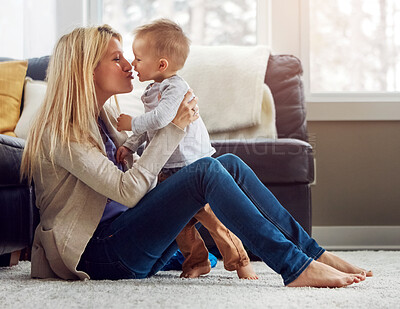 Buy stock photo Love, woman and boy child kiss in living room by mother, play and laugh for bonding together. Smile, happy mom with baby and family sit on floor, motherhood happiness and hugs for toddler at home