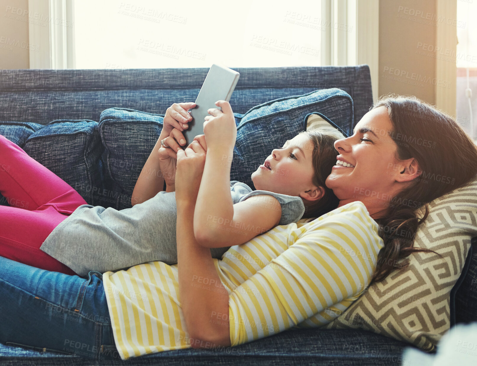 Buy stock photo Mother, child and relax on sofa with tablet for online streaming service, movies or ebook reader on holiday. Happy family, woman or mom with daughter on lounge and digital tech for e learning at home