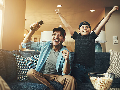 Buy stock photo Television, child and man with success on sofa for streaming, subscription or watching sports together. Kid, dad and popcorn with tv remote at home for bonding, celebration or live broadcast of match