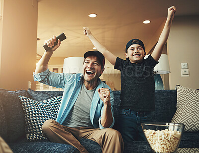 Buy stock photo Television, kid and dad with success on sofa for bonding, celebration and watching sports together. Son, man and popcorn with tv remote at home for streaming, network and live broadcast of match