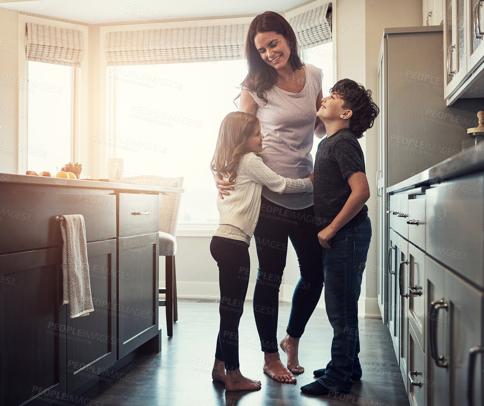 Buy stock photo Mother, children and hug in kitchen for talking, love and support for relationship in home. Mommy, kids and together in embrace for care or security, speaking and bonding in family house for comfort