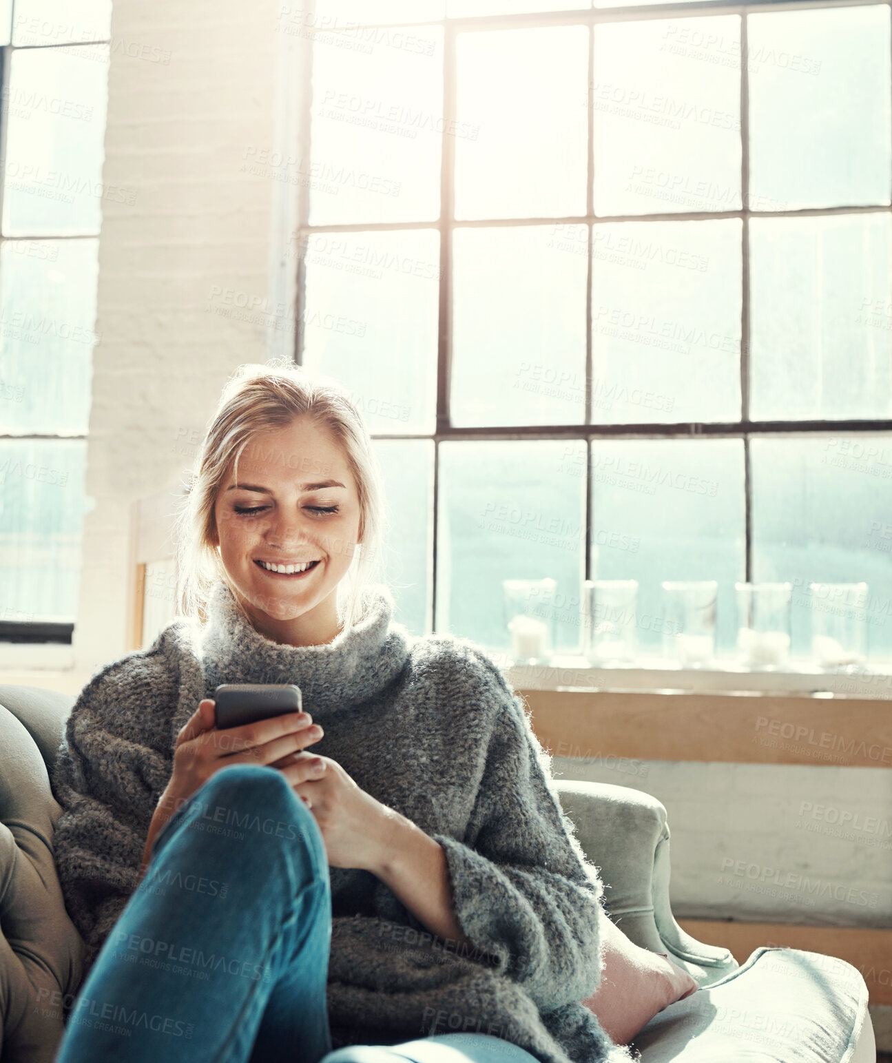 Buy stock photo Phone, smile and woman in home living room for social media, news and reading email. Smartphone, relax and happy girl on sofa to scroll on app, blog and chat on mobile website on internet in house