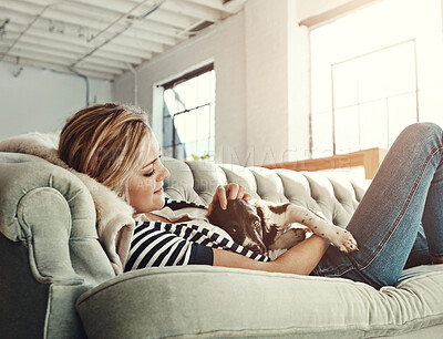 Buy stock photo Love, pet or relax with woman and dog on sofa in living room of home for bonding or cuddle. Friends, support or wellness and owner playing with puppy in apartment for attention, companion or loyalty