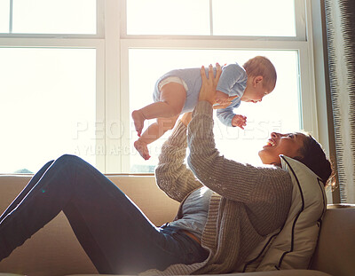 Buy stock photo Happy, mother and baby on sofa playing on weekend for love, bonding and relationship development in home. Care, woman and child together on couch in summer for safety, support or relax in living room