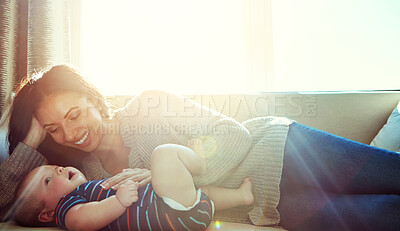 Buy stock photo Happy, mother and baby on sofa relax on weekend for love, bonding and relationship development in home. Care, woman and child together on couch in summer for safety, support or playing in living room