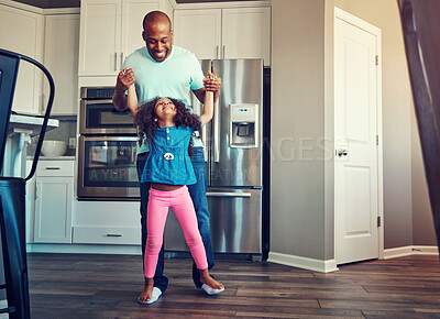 Buy stock photo Dance, happy and father with girl in home for bonding, relationship and fun together on weekend. Family, parenting and dad with child in kitchen for relax, playing and teaching dancer move to music