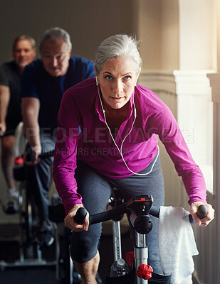 Buy stock photo Senior, gym or woman on cycling bike in workout or cardio training for endurance, health or wellness. Class, exercise or elderly sports person on bicycle machine for fitness, challenge and energy