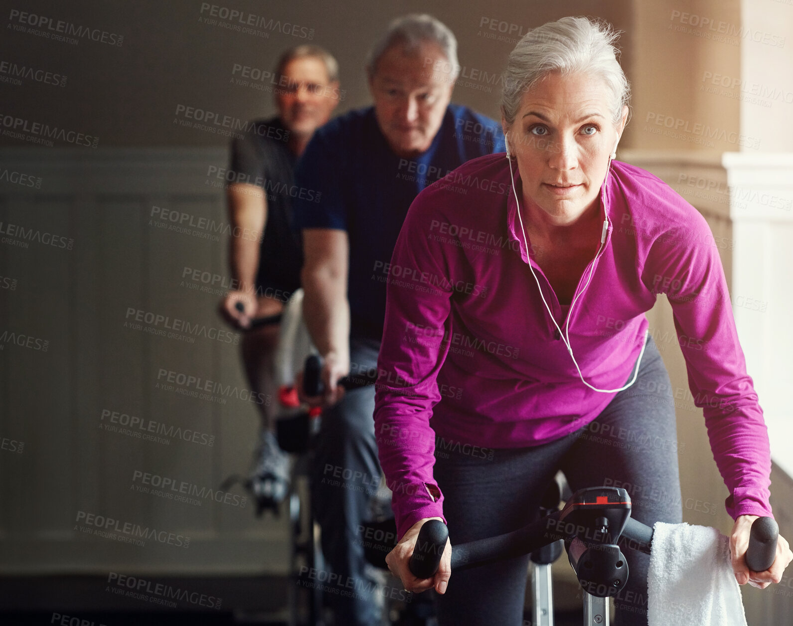 Buy stock photo Spin class, gym or senior woman on bike in workout or training for cycling progress, health or wellness. Group, challenge or confident elderly person on bicycle machine for fitness or cardio exercise