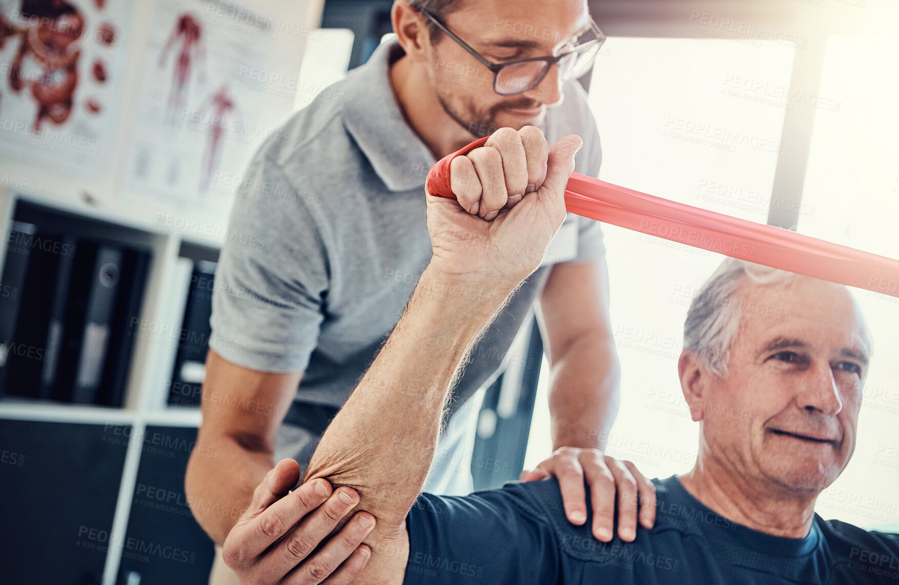 Buy stock photo Healthcare, physiotherapist and old man with resistance band, stretching and senior care rehabilitation. Physio, caregiver and elderly patient for mobility training, exercise and help in retirement.