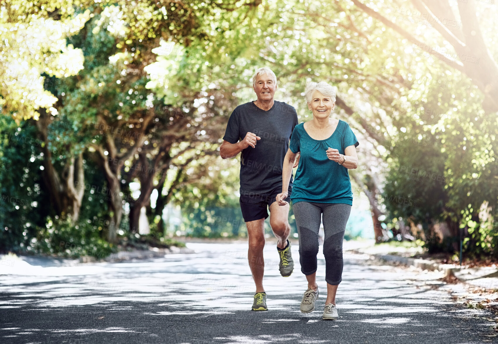 Buy stock photo Running, outdoor and old couple with fitness, healthy and cardio with challenge, retirement and wellness. Park, elderly man and mature woman with training, exercise and hobby with sunshine and nature