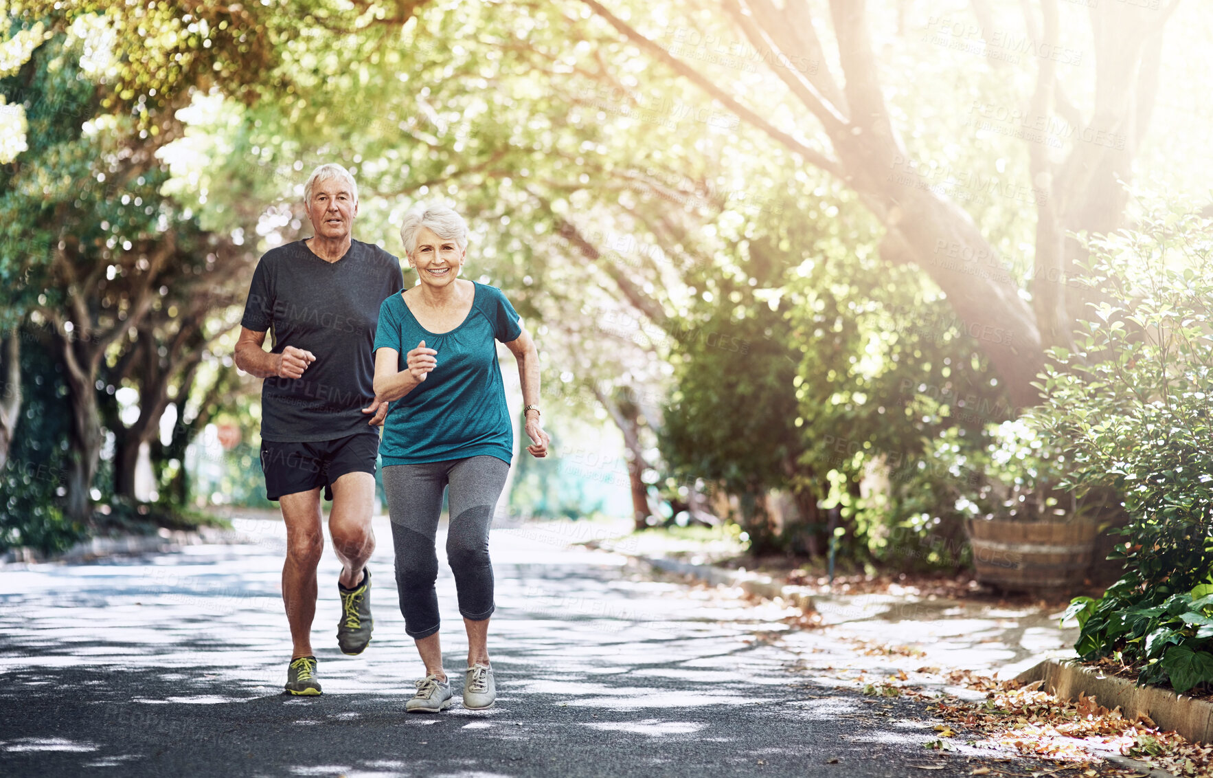 Buy stock photo Running, outdoor and old couple with fitness, sunshine and bonding together with challenge, activity and wellness. Park, mature man and senior woman with training, retirement and hobby with cardio