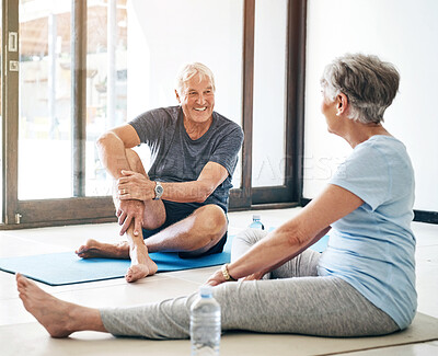 Buy stock photo Fitness, senior couple and talking on yoga mats together for rest, recovery and break from workout at home. Mature, man and woman with smile, water bottle and conversation for exercise and wellness