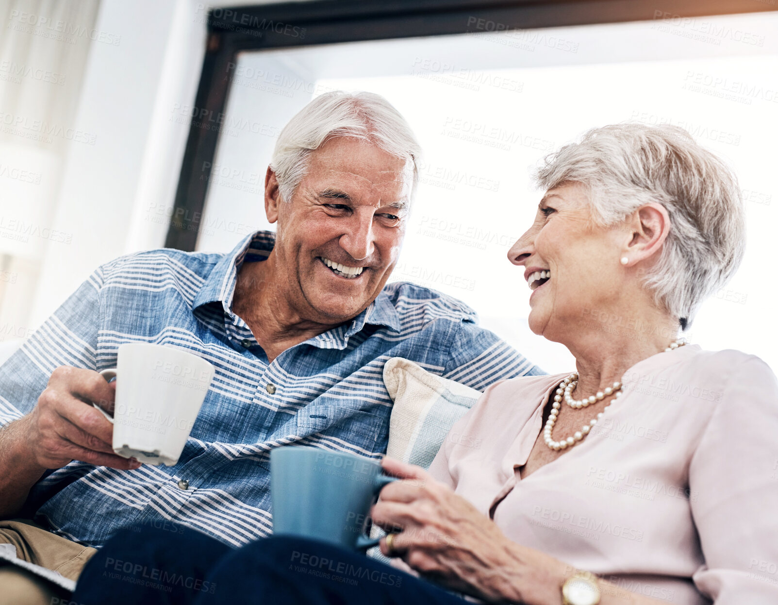 Buy stock photo Coffee, love and smile with senior couple in retirement home together for bonding or laughing. Funny, happy or relax with elderly man and woman in apartment for conversation, marriage or wellness