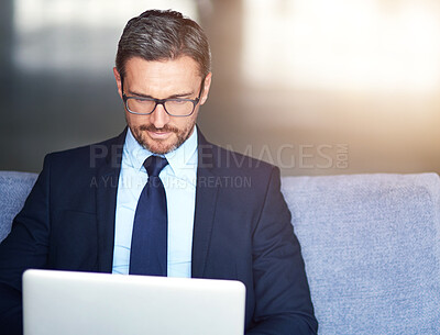 Buy stock photo Laptop, lobby and business man on sofa in office for email, information or research for administration. Break, computer and corporate with professional employee typing online report in workplace