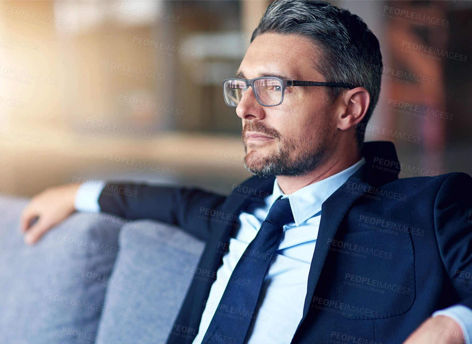 Buy stock photo Thinking, business man and sofa in office for startup inspiration, ideas or company growth. Lens flare, relax and confident male employee in thought for decision, problem solving or career goals