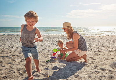 Buy stock photo Happy, mother and children playing on the beach on holiday, travel or adventure in summer. Boy, mom and kids with parent and outdoor ocean for fun energy and happiness with a game while running