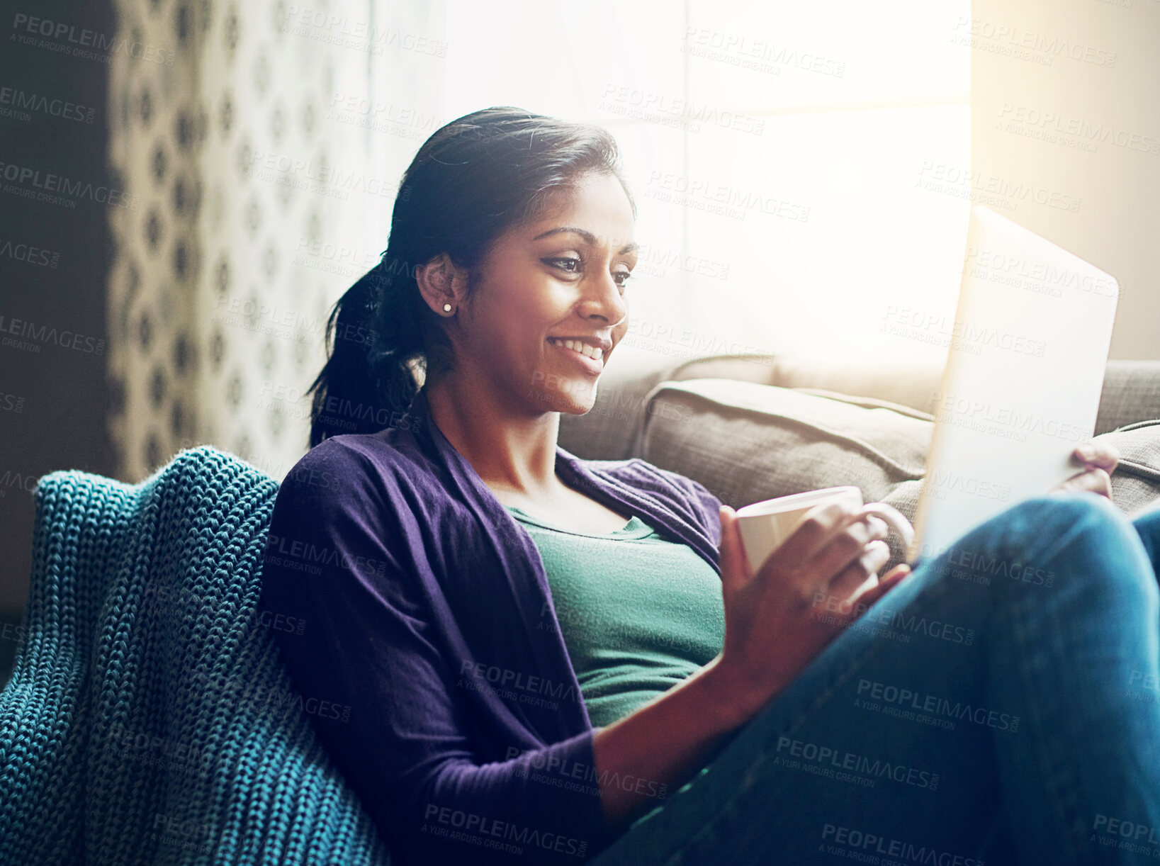 Buy stock photo Home, Indian woman and tablet on sofa for movie, relax and comfortable for ebook reading in living room. Apartment, happy girl and digital for streaming comedy, film and watch series with coffee cup