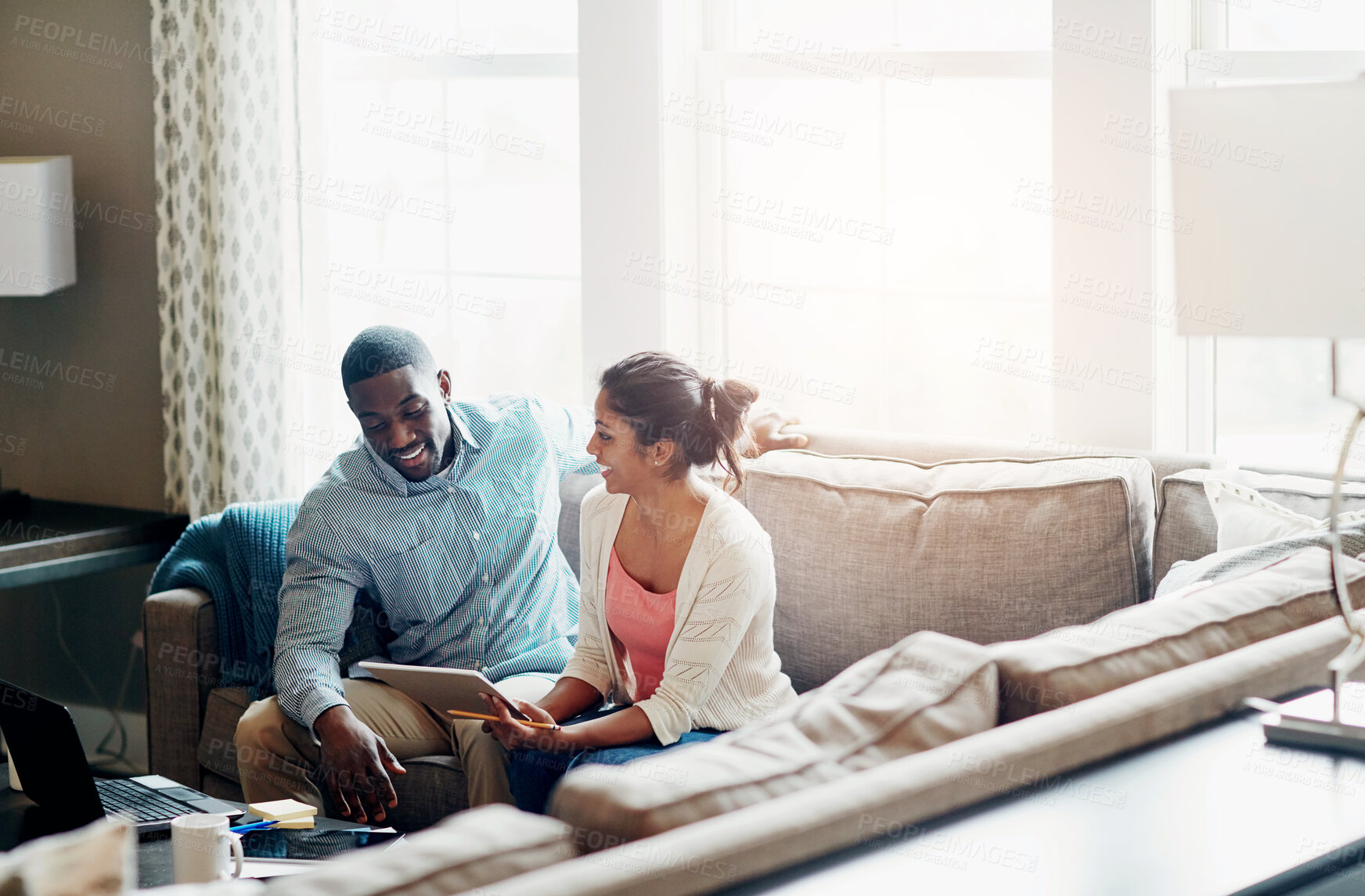 Buy stock photo Notebook, couple and discussion on sofa in morning for work, payments and rent with tax in living room. Sunlight, coffee and technology with people on couch, cover and debt with finance for mortgage.