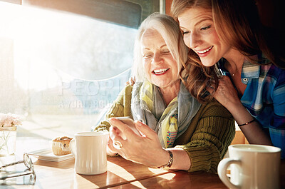 Buy stock photo Mother, daughter and mobile phone in cafe with coffee for social media, internet meme or bonding together. Date, senior lady and woman for networking, communication or online post in restaurant